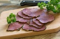 Thin slices of cold beef coated with pepper