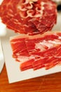 Thin slices of cured jamon on serving plate Royalty Free Stock Photo
