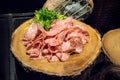 Thin slices of cured meat salami on rustic wood stand Royalty Free Stock Photo