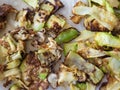 Thin slices of fried zucchini lying on kitchen napkins