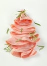 Thin slices of ham with rosemary