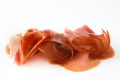 Thin slices of spanish serrano ham isolated on white background Royalty Free Stock Photo