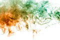 Thin smoothly curling streams of colored smoke dissolve on a white background like watercolor backlit with orange and green