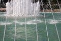 Thin streams of water on the fountain. Drops of water and fresh streams of moisture.