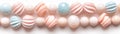 A thin strip of pastel beads is placed on a white surface. The beads vary in shape and color, providing options for craft projects Royalty Free Stock Photo
