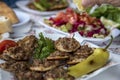 Thin turkish pita bread covered with minced meat and onions with flavored lemon in Tarsus city, close up