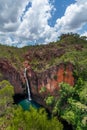 Thin waterfall plummets down into the turquoise lake below