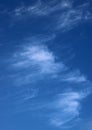 Thin wispy cirrus clouds seen against blue sky