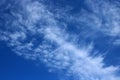 Thin wispy cirrus clouds seen against blue sky