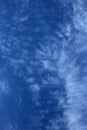 Thin wispy cirrus clouds seen against blue sky