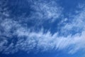 Thin wispy cirrus clouds seen against blue sky