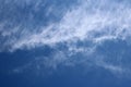 Thin wispy cirrus clouds seen against blue sky