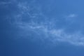 Thin wispy cirrus clouds seen against blue sky