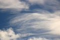 Thin wispy white clouds in a blue sky on sunny day