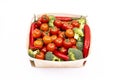 thin wooden tray with bulk cherry tomatoes, broccoli chunks and red hot chili peppers Royalty Free Stock Photo