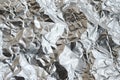 Thin wrinkled sheet of crushed tin aluminum silver foil backgrou Royalty Free Stock Photo