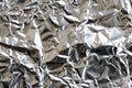 Thin wrinkled sheet of crushed tin aluminum silver foil backgrou Royalty Free Stock Photo