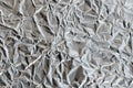 Thin wrinkled sheet of crushed tin aluminum silver foil backgrou Royalty Free Stock Photo