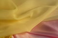 Thin yellow fabric on a pink silk
