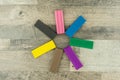 Things for the development of children`s abilities: 7 pieces of clay of different colors lie in radial symmetry on the wooden