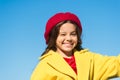 Things gonna be alright. Girl wink cheerful face blue sky background. Kid girl wear hat and coat cheerful satisfied with