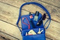 Things from open lady purse. Cosmetics, money and women`s accessories fell out of blue handbag. Royalty Free Stock Photo