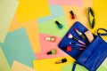 Things from open lady purse. Cosmetics and women`s accessories fell out of blue handbag on colourful background. Royalty Free Stock Photo