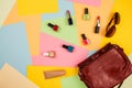 Things from open lady purse. Cosmetics and women`s accessories fell out of red handbag Royalty Free Stock Photo