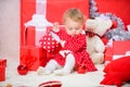 Things to do with toddlers at christmas. Gifts for child first christmas. Little baby girl play near pile of gift boxes Royalty Free Stock Photo