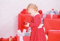 Things to do with toddlers at christmas. Gifts for child first christmas. Little baby girl play near pile of gift boxes Royalty Free Stock Photo