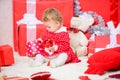 Things to do with toddlers at christmas. Little baby girl play near pile of gift boxes. Family holiday. Gifts for child Royalty Free Stock Photo