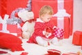 Things to do with toddlers at christmas. Little baby girl play near pile of gift boxes. Family holiday. Gifts for child Royalty Free Stock Photo