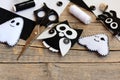 Halloween felt embellishments. Felt ghost, spider, owl embellishments on a vintage wooden table. Sewing tools and materials set