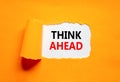 Think ahead symbol. Concept words Think ahead on beautiful white paper on a beautiful orange background. Business, support, Royalty Free Stock Photo