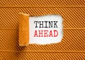 Think ahead symbol. Concept words Think ahead on beautiful white paper on a beautiful brown paper background. Business, support, Royalty Free Stock Photo