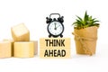 Think ahead symbol. Concept words Think ahead on wooden blocks on a beautiful white background. Black alarm clock. Business, Royalty Free Stock Photo