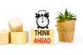 Think ahead symbol. Concept words Think ahead on wooden blocks on a beautiful white background. Black alarm clock. Business, Royalty Free Stock Photo