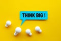 Think big,Great idea,Business creativity concepts with lightbulb and text on yellow background Royalty Free Stock Photo