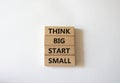 Think big start small symbol. Concept words Think big start small on wooden blocks. Beautiful white background. Business and Think Royalty Free Stock Photo