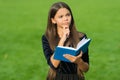 Think clearly and rationally. Serious child think holding book green grass. Critical and creative thinking skills Royalty Free Stock Photo