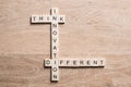 Think different concept of crossword puzzle on wooden surface or table Royalty Free Stock Photo