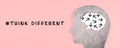 Think different stands on the pink background, head with brain, being a nonconformist, standing out from the crowd, creative