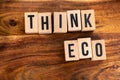 ` THINK ECO ` text made of wooden cube on  wooden background Royalty Free Stock Photo