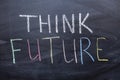 Think future inscription on a chalkboard. The concept of development and a positive Outlook for the future Royalty Free Stock Photo