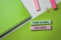 Think Global Act Local text on top view office desk table of Business workplace and business objects Royalty Free Stock Photo