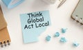 think globally act locally text concept write on wall paper