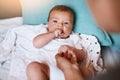 Think it might be milk time again. a young woman bonding with her baby boy at home.