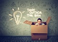 Think outside box concept. Young woman coming out of box Royalty Free Stock Photo