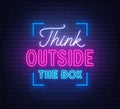 Think outside the box - neon lettering on brick wall background Royalty Free Stock Photo