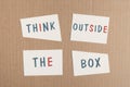 Think outside the box is standing on pieces of white paper, brainstorming for new ideas, being innovative, business concept Royalty Free Stock Photo